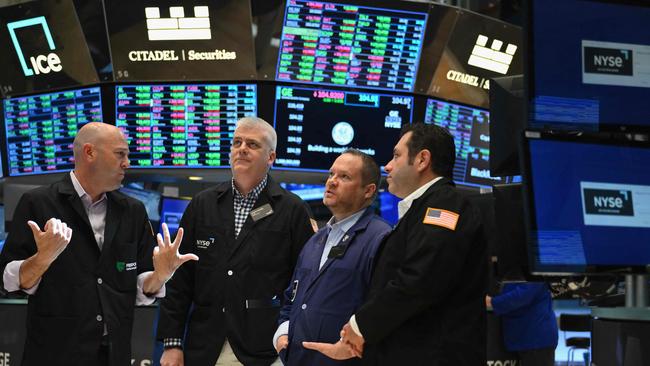 People work on the floor at the New York Stock Exchange. Wall St has rallied over the past two weeks. (Photo by ANGELA WEISS / AFP)