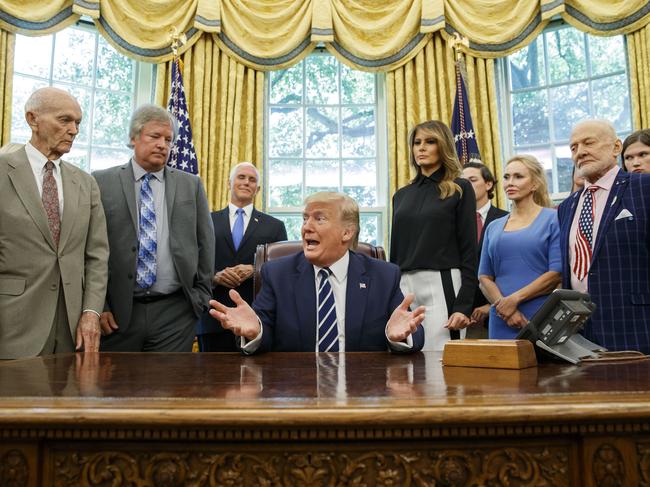 President Donald Trump, accompanied by Apollo 11 astronauts Michael Collins, left, and Buzz Aldrin, right, and Eric "Rick" Armstrong, son of Neil Armstrong, second from left, with Vice President Mike Pence and first lady Melania Trump. Picture: AP