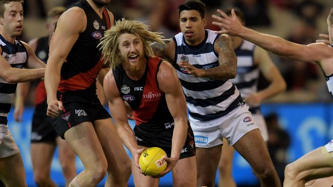 Dyson Heppell handballs out of the pack against Geelong.