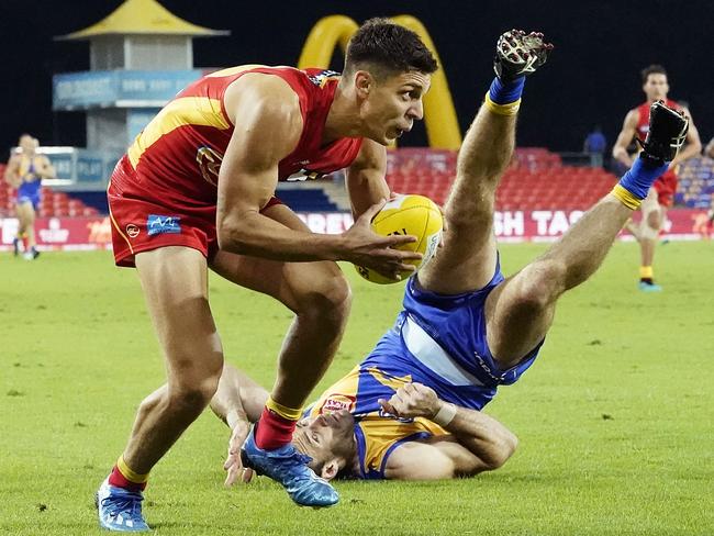 Sean Lemmens escapes an attempted tackle by the Eagles’ Shannon Hurn. Picture: AAP