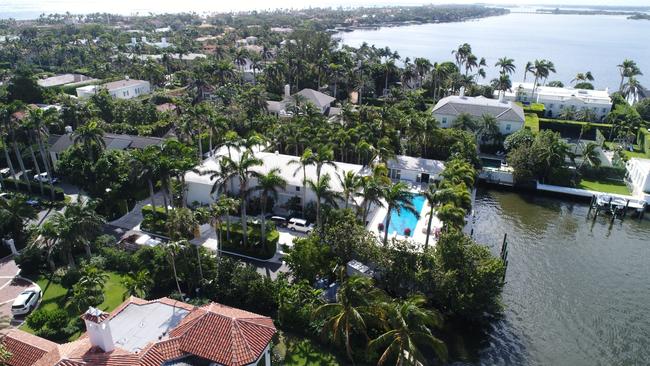 The palm-bordered waterfront villa was designed by the architect John Volk. Picture: Getty