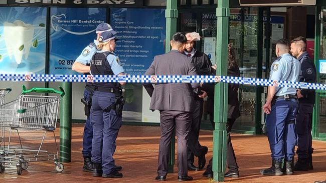 Police investigating the scene of the armed robbery.