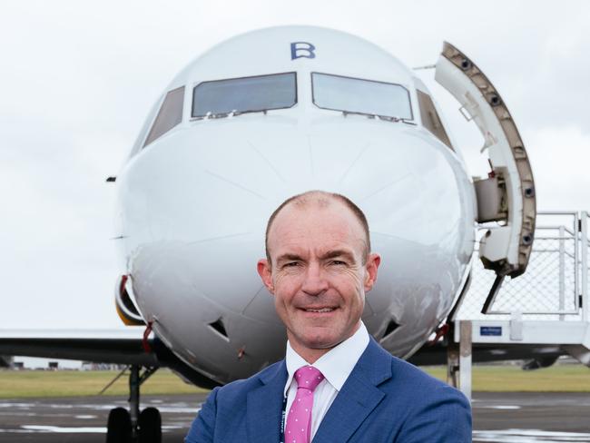 Alliance Airlines CEO Lee Schofield in front of a plane