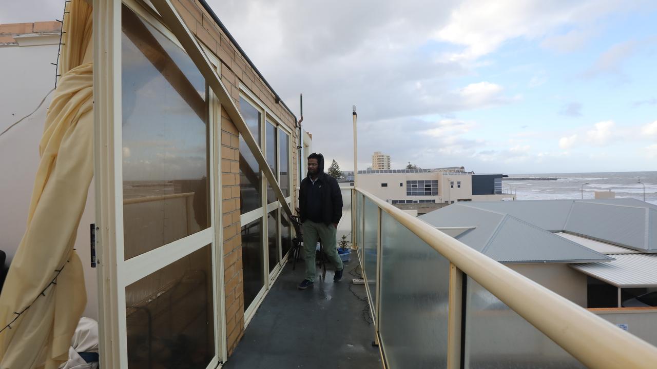 Surinder Kumar outside his Glenelg North apartment, where the roof blew off in the storm. Picture: AAP / Russell Millard