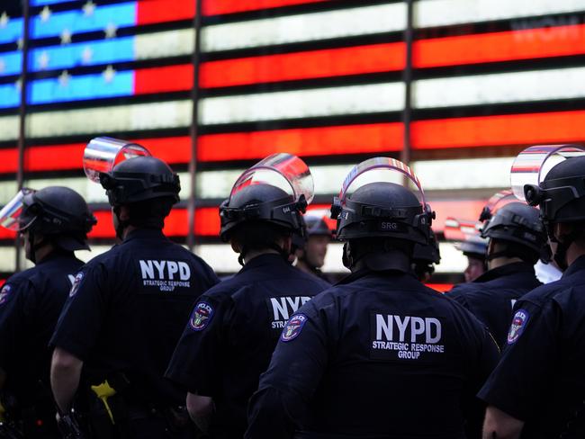 NYPD police officers watch demonstrators in Times Square during a "Black Lives Matter" protest. Picture: AFP