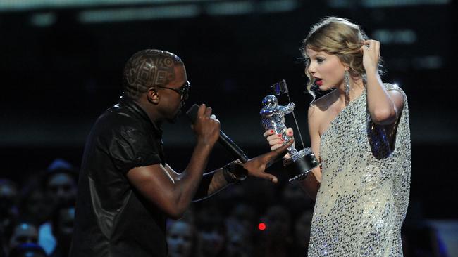 Kanye West jumps onstage as Taylor Swift accepts her award for the Best Female Video award during the 2009 MTV Video Music Awards.