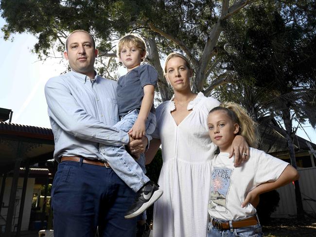 29/3/2021 - Maurice and Danielle Wilcox, pictured with their children Ella, 8 and Ollie, 6, have met resistance from West Torrens Council to have a river red gum tree removed from their backyard in Kurralta Park. They have two young children and the tree has recently dropped limbs. Council has said just prune the tree and all is ok. Their application goes before a council committee next month. Picture: Naomi Jellicoe