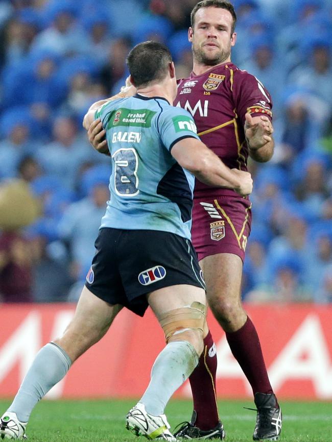 Paul Gallen launches a punch at Nate Myles’s mighty maroon forehead.