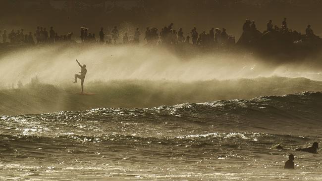 Surfers enjoy the large swell – thanks to Tropical Cyclone Seth – and a big crowd of onlookers at Snapper Rocks on the Gold Coast on Sunday. Picture: Lyndon Mechielsen