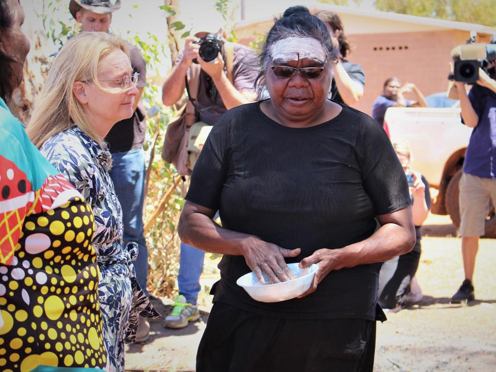 Kumanjayi Walker's mother Leeanne Oldfield paints Coroner Elisabeth Armitage’s forehead. Picture: Jason Walls