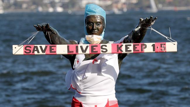 The bronze Eliza statue on the Perth’s Swan river is seen dressed in medical protective equipment. WA has eased its limits on crowd gatherings. Picture: AAP