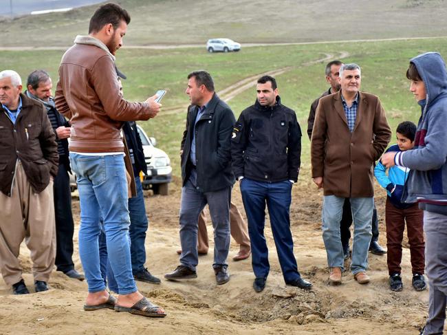 Iraqi Kurds stand around a crater caused by a reportedly Iranian missile initially fired at Iraqi bases housing US and other US-led coalition troops, in the Iraqi Kurdish town of Bardarash. Picture: AFP