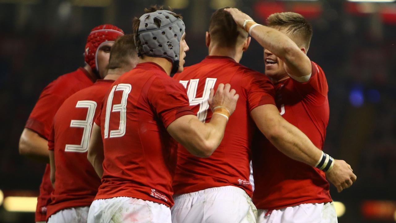 Wales star George North celebrates with teammates after scoring against Scotland.