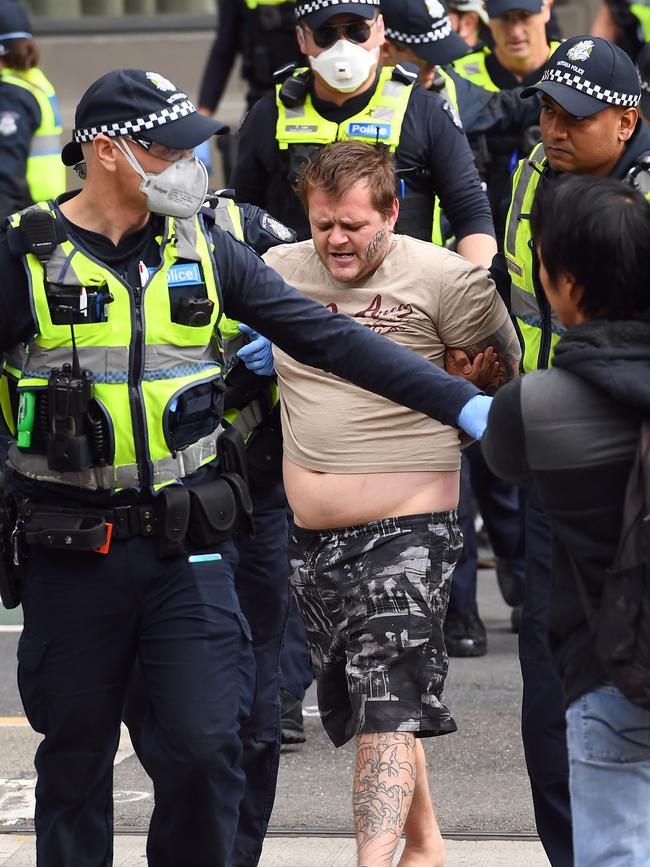 An anti-lockdown protester is arrested in Melbourne. Picture: AFP