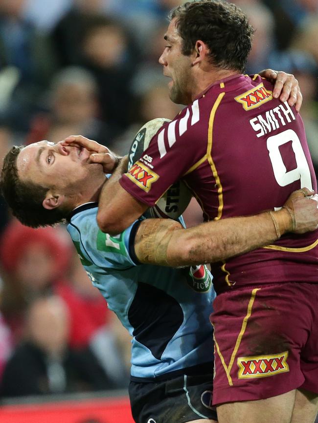 Cameron Smith palms off James Maloney at Suncorp Stadium. Picture: Darren England.