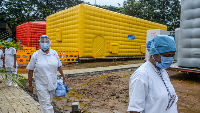 Medical staff at the Tata Memorial Centre cancer hospital in Mumbai prepare to screen patients for COVID-19. Picture: AFP