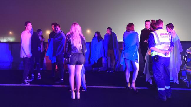 The group wait to transferred to another bus on the M4. Picture: Gordon McComiskie