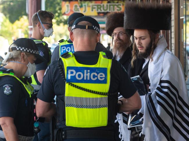 Police fine members of a Jewish Synagogue that have broken the Social distancing rule in Glen Eira road, Ripponlea. Picture: Tony Gough