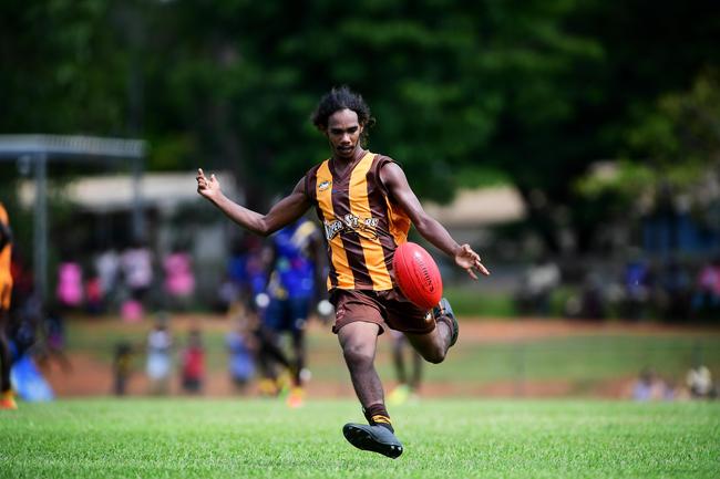 Tapalinga Superstars Brooklyn Alamankinni goes boot to ball against the Ranku Eagles during this year's 49th Annual Tiwi Grand Final at Wurrumyanga Oval on Bathurst Island Picture: Justin Kennedy