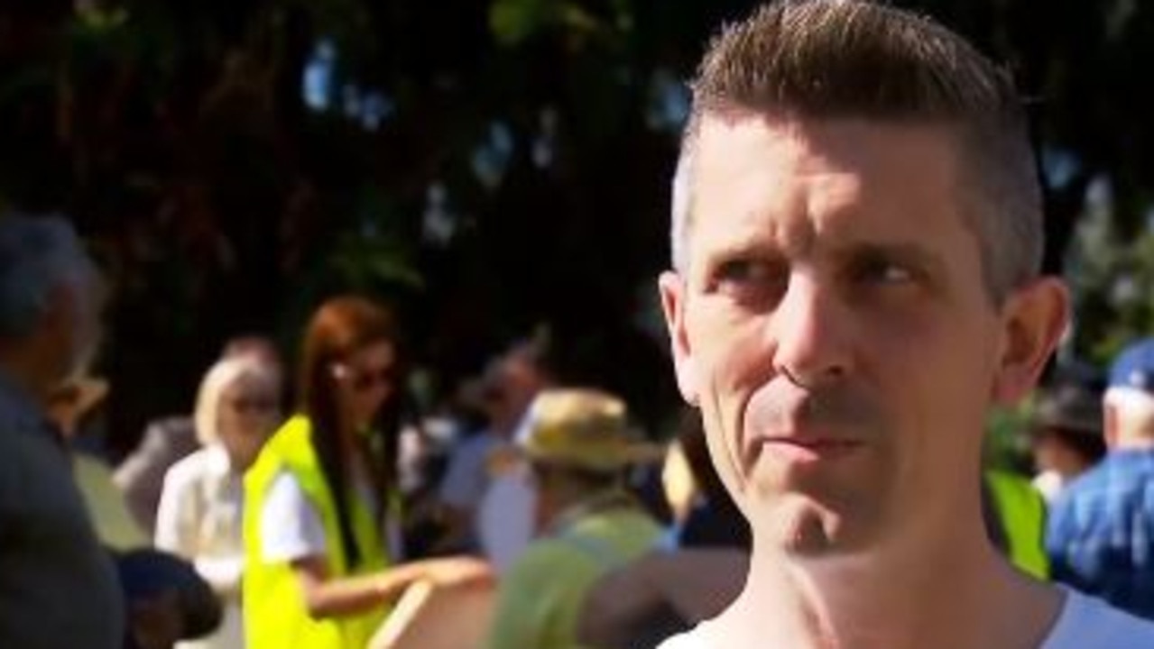 Lee Lovell, whose wife was killed in a Boxing Day home invasion talks to Channel 7 at the rally. Photo: Channel 7