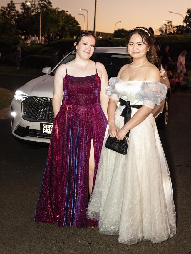 Ambah More (left) and Wendy Xue arrive at Harristown State High School formal at Highfields Cultural Centre, Friday, November 18, 2022. Picture: Kevin Farmer