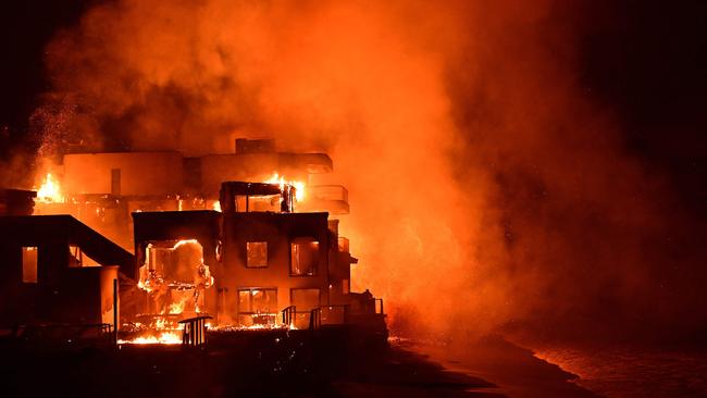 A beach house is engulfed in flames as the Palisades Fire burns along Pacific Coast Highway in Malibu, California. Picture: AGUSTIN PAULLIER / AFP
