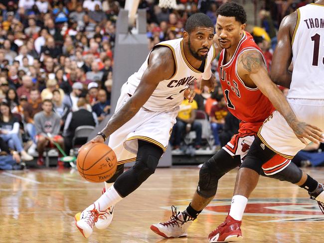 Kyrie Irving #2 of the Cleveland Cavaliers drives around the defence of Derrick Rose #1 of the Chicago Bulls.