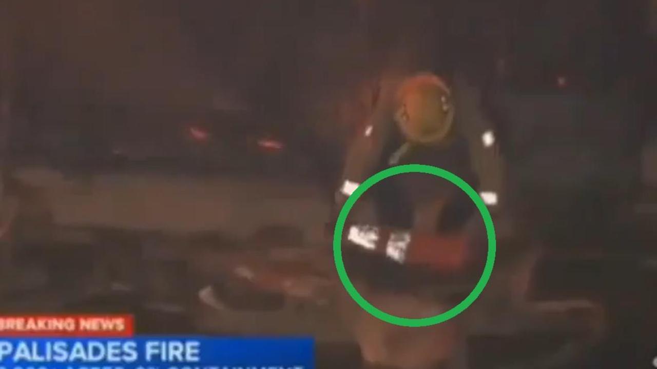 A fireman was pictured scooping water with a traffic cone.