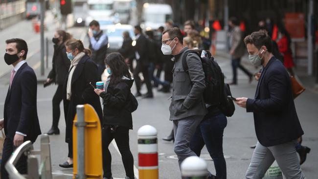 Pedestrians cross Flinders Street as Melbourne reopens after another COVID-19 lockdown. Picture: NCA NewsWire / David Crosling