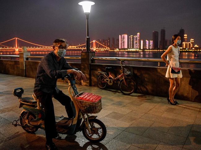 Locals out and about in Wuhan, ground zero of the coronavirus. Picture: AFP