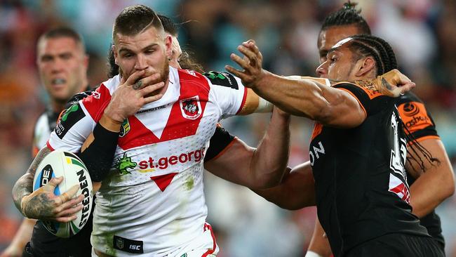 SYDNEY, AUSTRALIA - SEPTEMBER 05: Josh Dugan of the Dragons is tackled during the round 26 NRL match between the St George Illawarra Dragons and the Wests Tigers at ANZ Stadium on September 5, 2015 in Sydney, Australia. (Photo by Cameron Spencer/Getty Images)