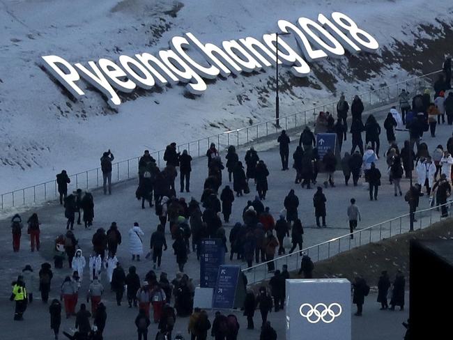 People arrive at the Olympic Stadium ahead of the opening ceremony. Picture: AP Photo/Kirsty Wigglesworth