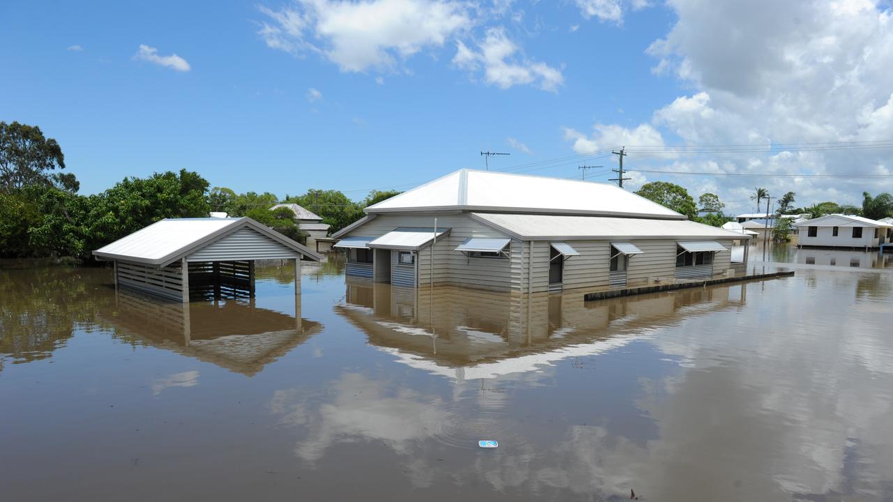 RECEDING WATER: Flooded homes in Tantitha Street slowly emerge from the receding flood waters during the 2013 floods in Bundaberg. Photo: Mike Knott / NewsMail