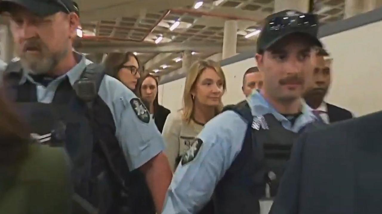 Optus CEO Kelly Bayer Rosmarin, who faces an uncertain future at the telco, leaves a Senate inquiry flanked by police security. Picture: Seven