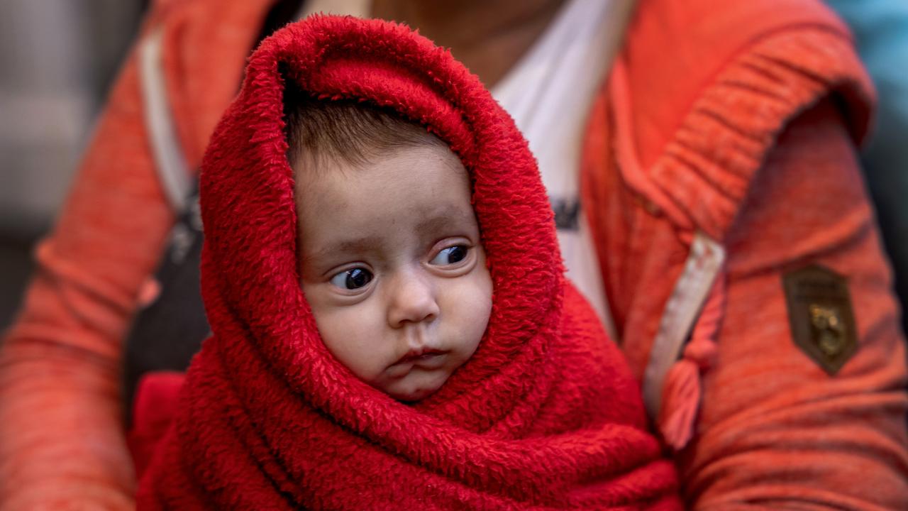 A Ukrainian woman holds her 3-month-old baby at the Western Railway Station as they flee Ukraine on March 9, 2022 in Budapest, Hungary. Toowoomba and southwest Queensland has revealed it will be prepared to resettle refugees from Ukraine. (Photo by Janos Kummer/Getty Images)