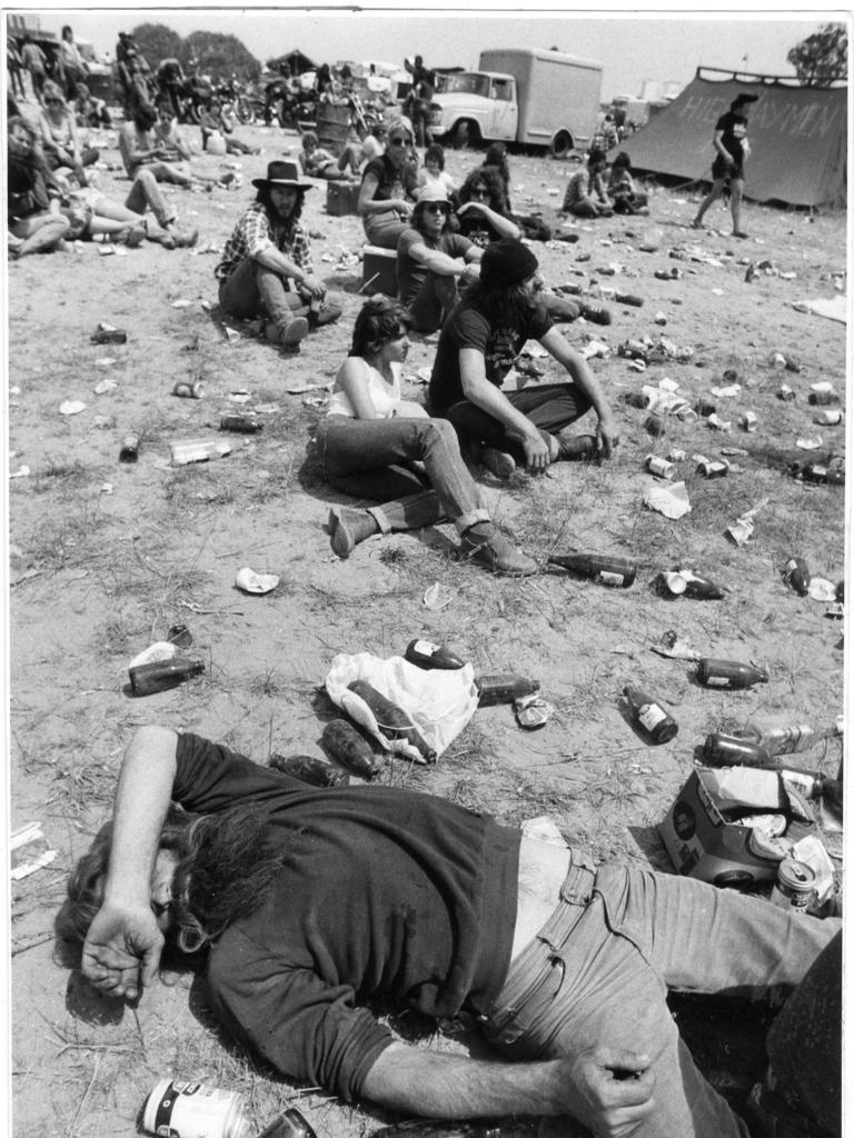 Music fan sleeping among the litter of cans and bottles at Ponde rock music festival, held by the Hell's Angels Motorcycle Club in Ponde near Mannum, SA, 19 Oct 1983. (Pic by unidentified staff photographer)