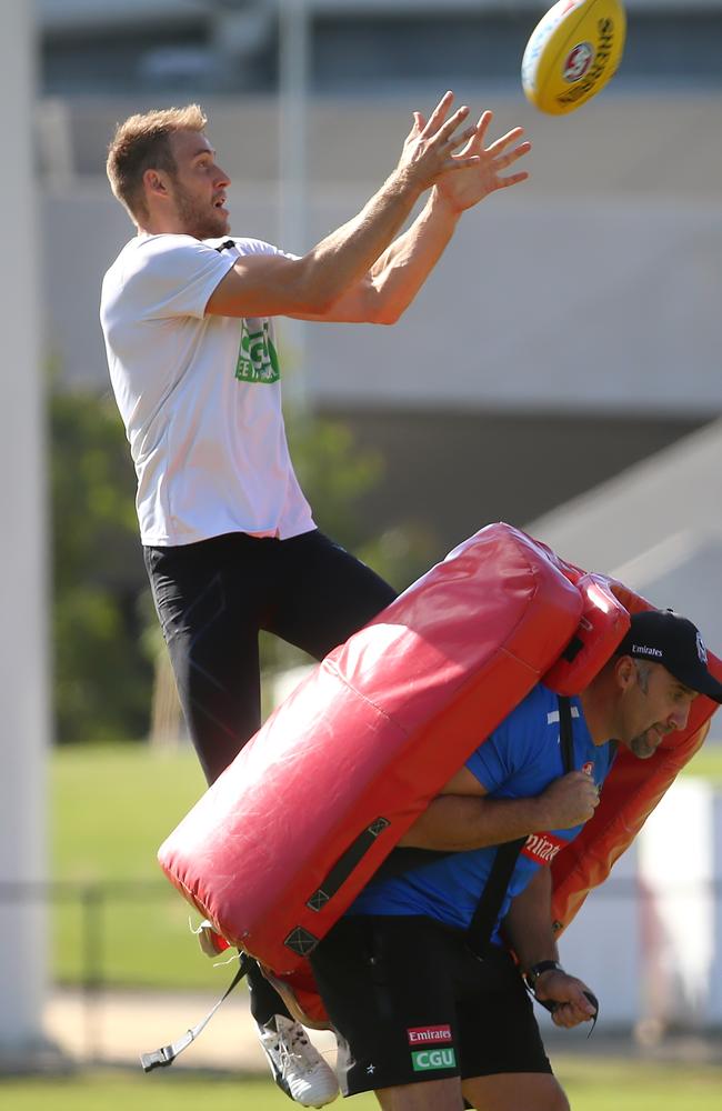Ben Reid takes a speccy over Anthony Rocca at Collingwood training on Thursday. Picture: Hamish Blair