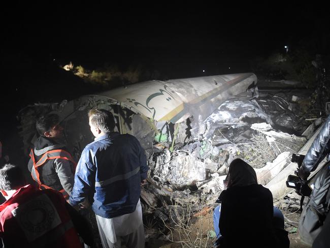 Pakistani officials of Pakistan International Airlines (PIA) look at the wreckages of crashed PIA passenger plane Flight PK661 at the site in the village of Saddha Batolni in the Abbottabad district of Khyber Pakhtunkhwa province on December 7, 2016. Picture: AFP PHOTO / AAMIR QURESHI