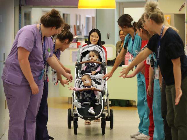 Mum Bhumchu Zangmo leaves the Royal Children's Hospital with twins Nima and Dawa while nurses in the ward say their goodbyes. Picture: Alex Coppel.