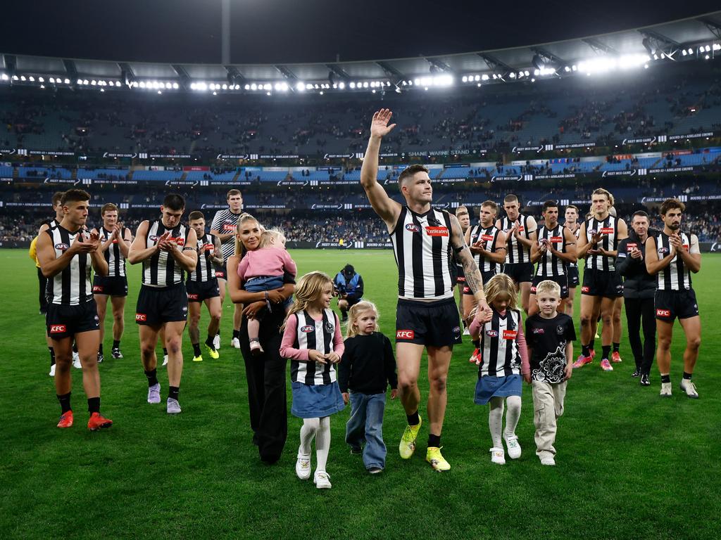 Crisp walks off the MCG with his family. Picture: Michael Willson/AFL Photos