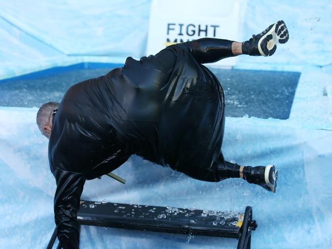 Fagan dressed as the reverend slips and hits the deck climbing out of the pool. Picture: Michael Klein