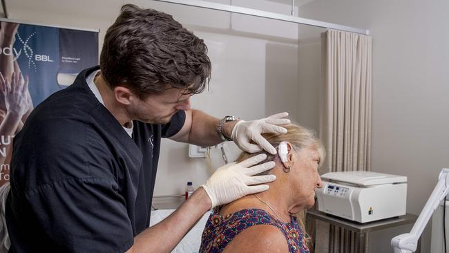 Specialist dermatologist Dr Andrew Freeman with patient Melissa Darnley, who had a skin cancer removed with very little scarring as a result. Picture: Jerad Williams