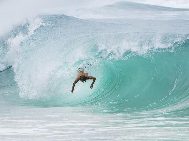 Body surfer Beau Foster flies down a wave at Moffat Beach. Strong winds and large swell has arrived on the Sunshine coast as Cyclone Oma continues to track towards South East Queensland. Photo Lachie Millard