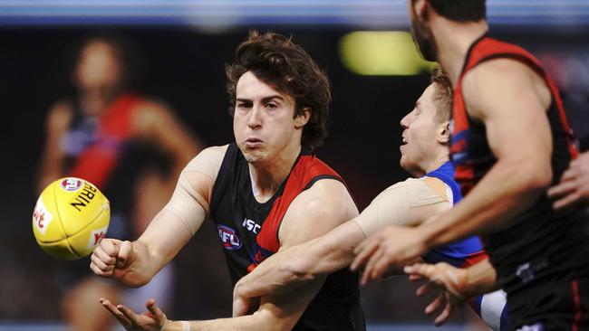 Andrew McGrath of the Bombers handballs during the Round 21 match against the Western Bulldogs. Picture: AAP Image/Michael Dodge