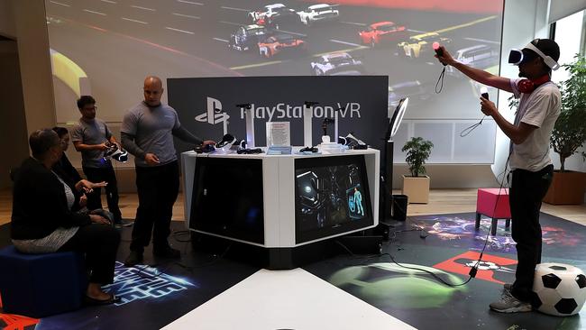 Customers try the new PlayStation VR at Sony Square in New York City. The $550 virtual reality headset arrived in Australia this week. Picture: Justin Sullivan/Getty Images/AFP