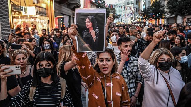 A protester holds a portrait of Mahsa Amini  during a solidarity rally in Turkey. Picture: AFP