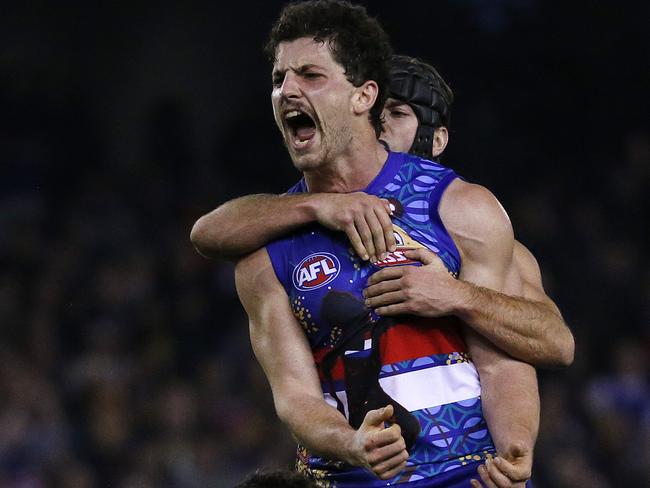 AFL - Western Bulldogs v West Coast Eagles at Etihad Stadium, Western Bulldogs Tom Liberatore kicks a goal in the last quarter to seal the win for the Dogs as Luke Shuey looks on. . 5th June 2016. Picture: Colleen Petch.