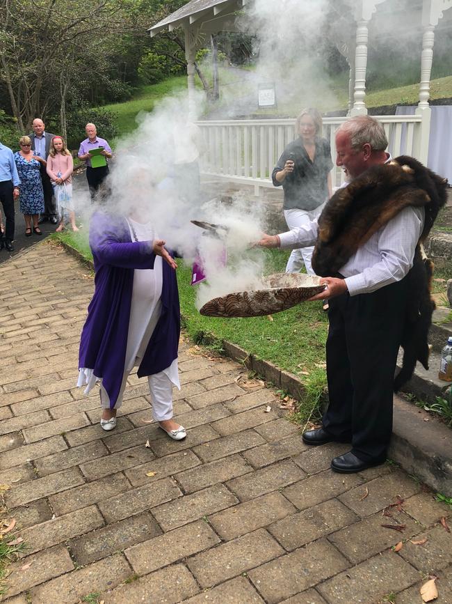 Susan Moylan-Coombs, an indigenous woman from Killarney Heights walks through the smoke during a smoking ceremony held on Monday. Picture: Jim O’Rourke.