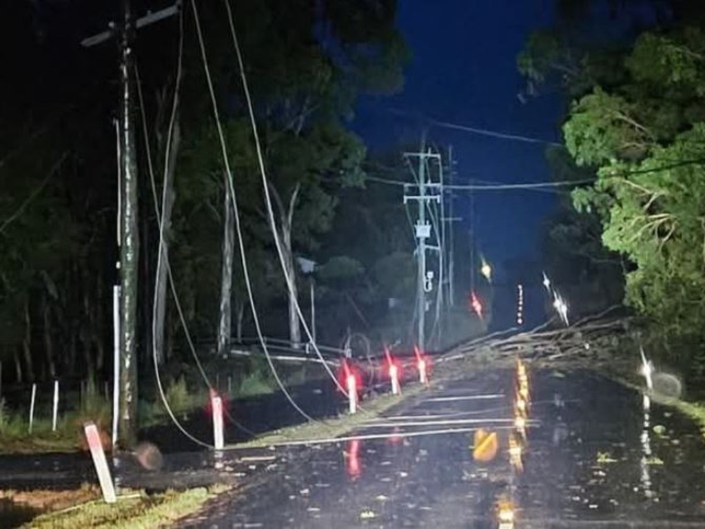 Giles Rd Redland Bay has multiple powerlines down and trees blocking road.