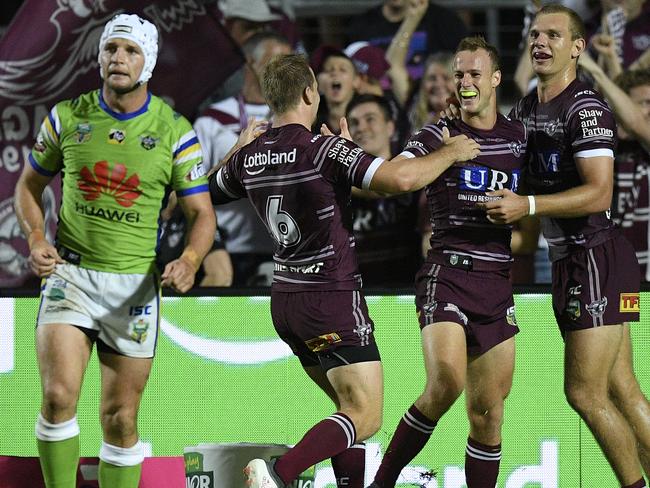 Daly Cherry-Evans celebrates with team mates after scoring a try.